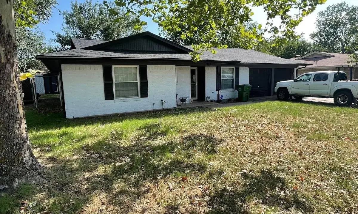 Professional roofing crew working on a residential roof in Manitowoc